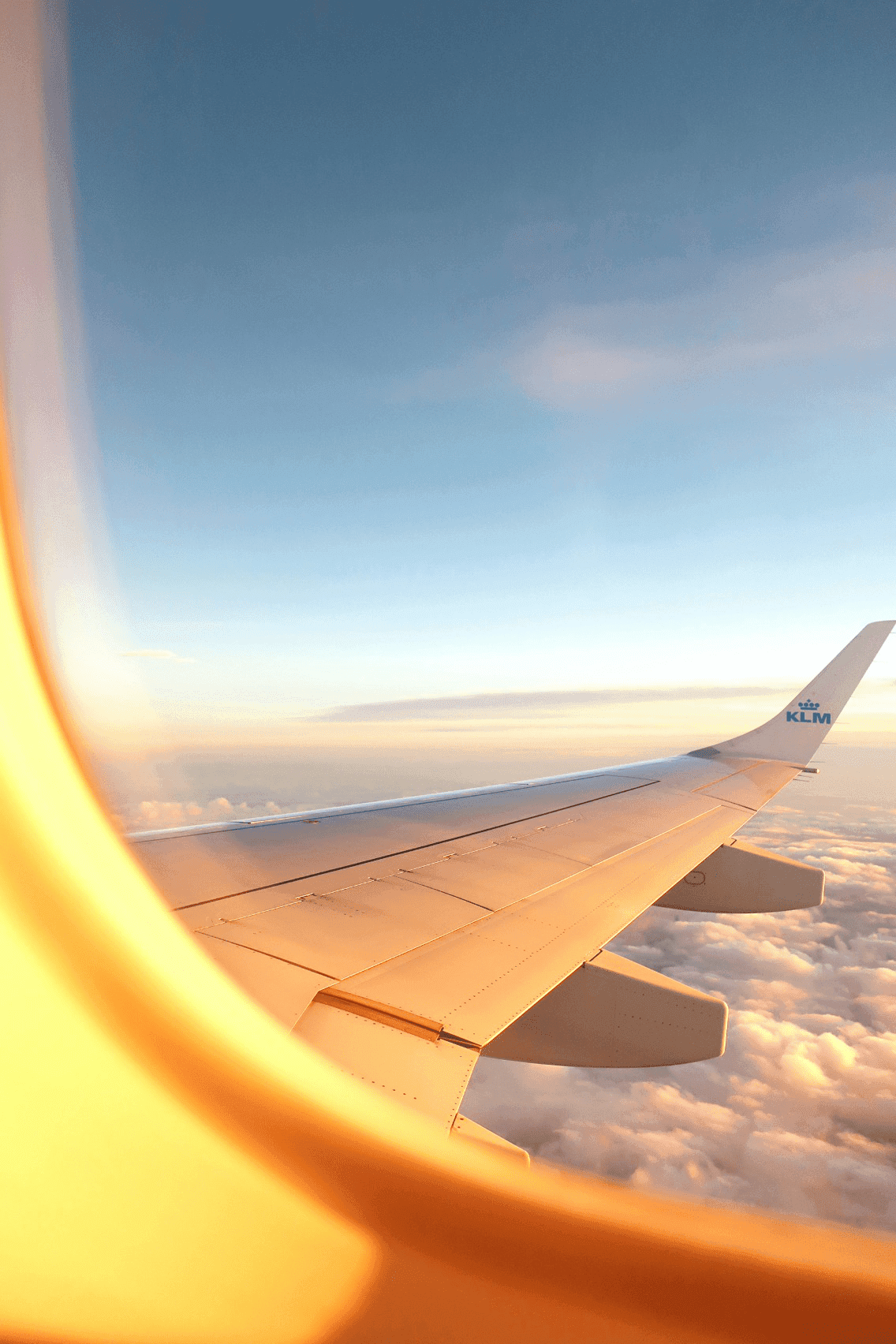 View through a passenger airplane window flying over the clouds