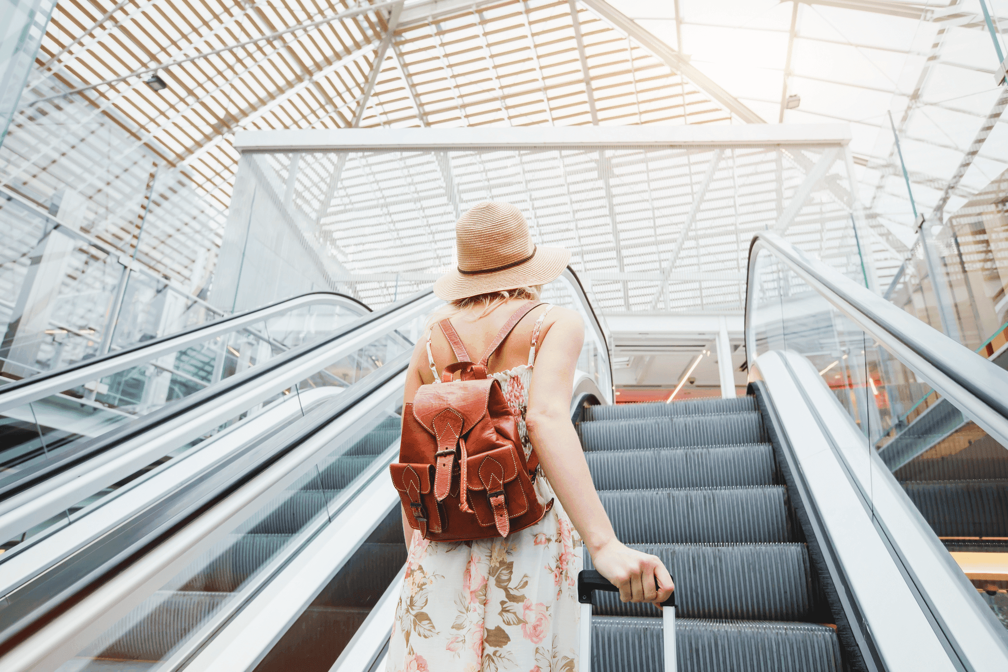 Traveler going up an escalator in airport